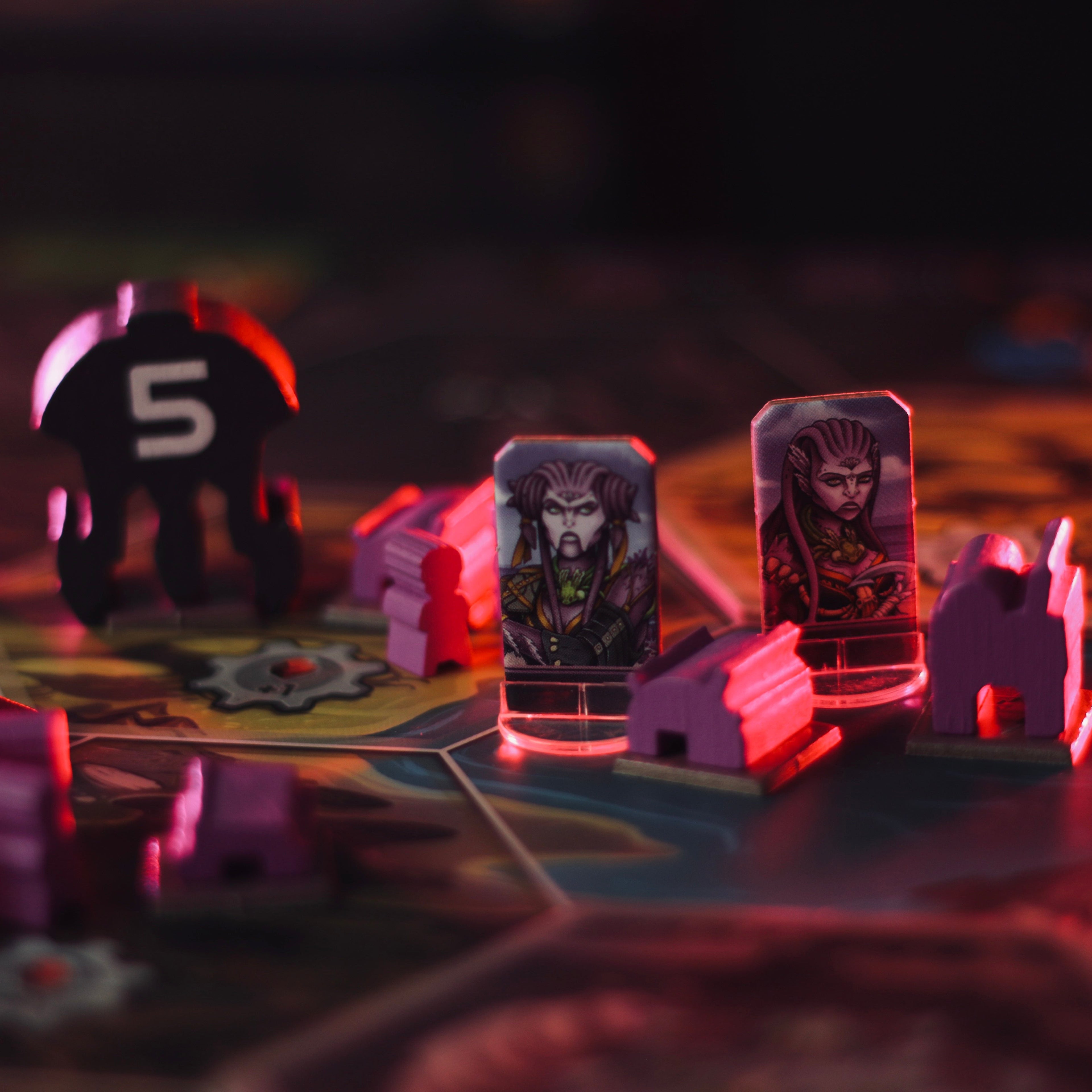 Board game pieces with characters and numbers on a dark surface