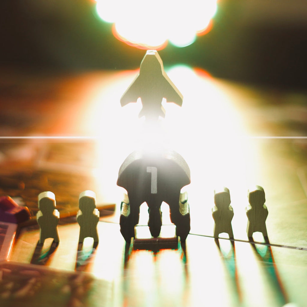 Toy figures on a table with a bright light source in the background