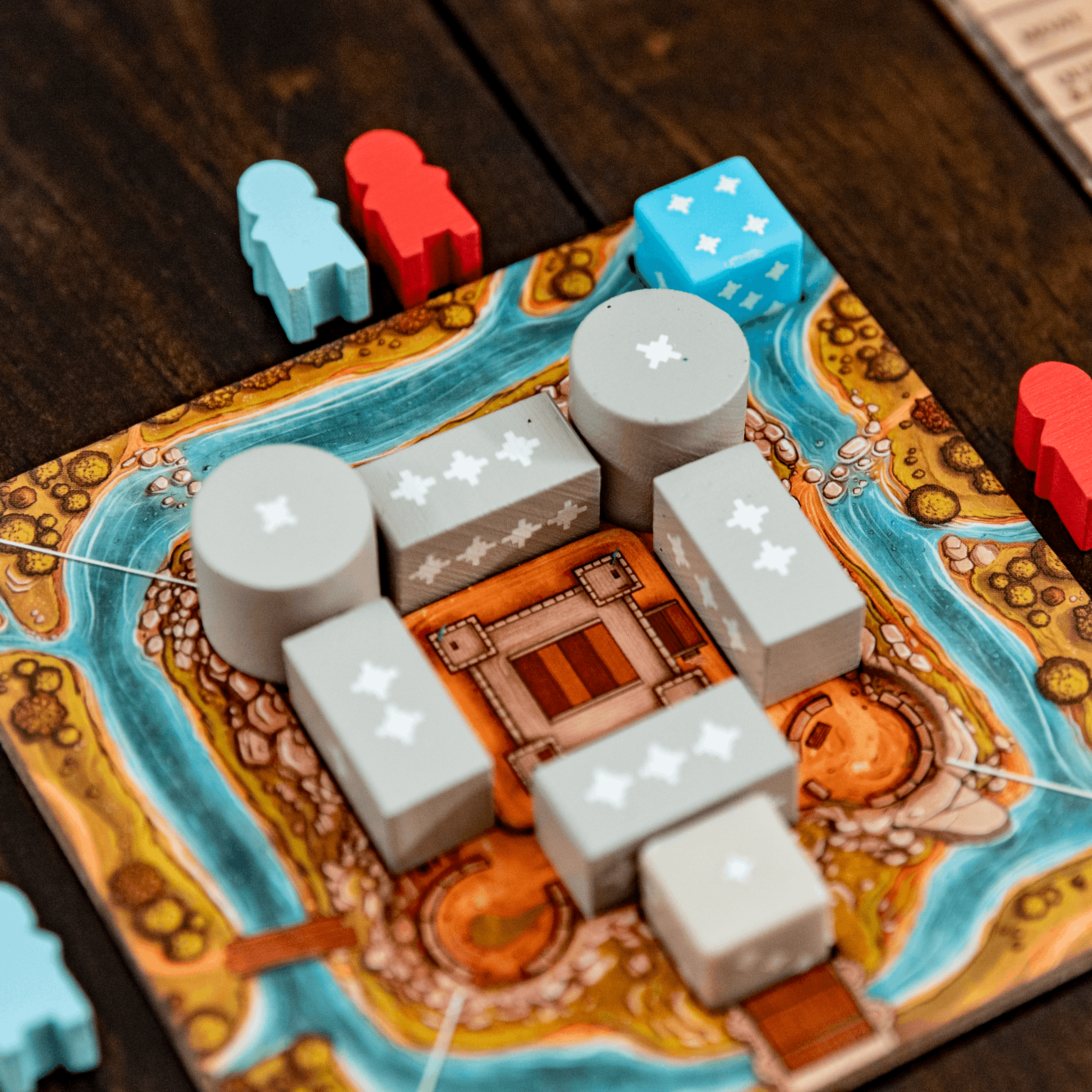 Board game with dice and pieces on a wooden surface