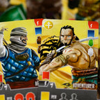 Two trading cards featuring warrior characters on a yellow background with other similar cards blurred in the background.